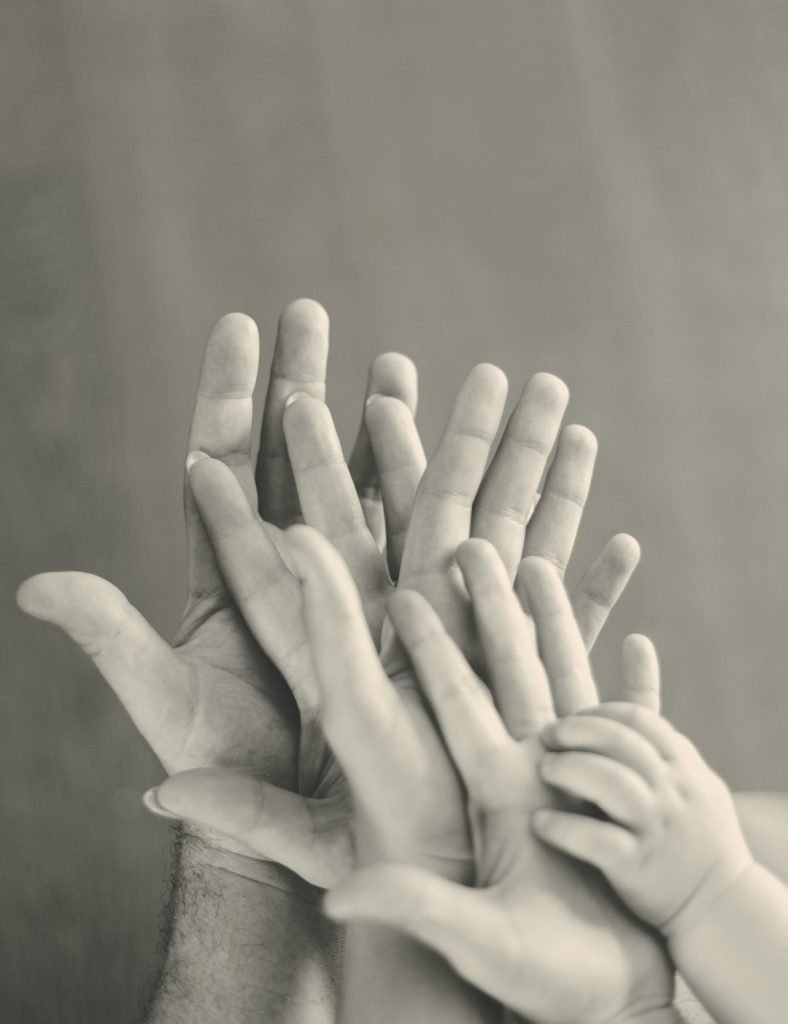 grayscale-photo-of-familys-hands-y5jvtoef-sk